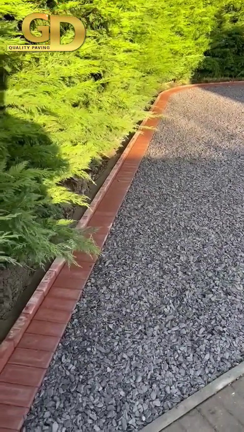 Block paved drive with decorative gravelling.
