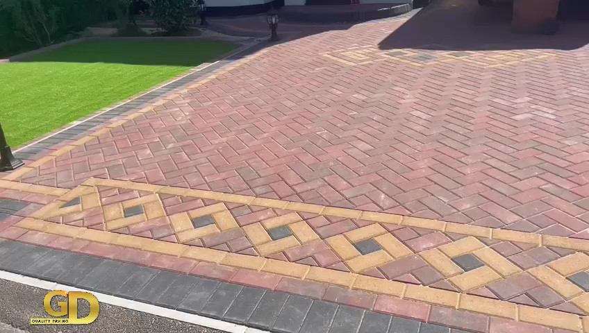 Red block paving with decorative insets on a drive in Parkgate, the Wirral.